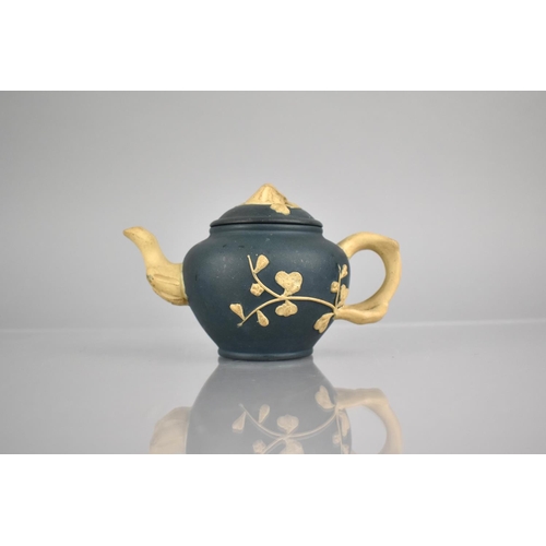 235 - A Chinese Yixing Blue Ground Teapot with Biscuit Stylised Blossoming Branches Handle, Finial and Spo... 