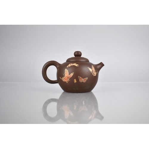 232 - A Chinese Yixing Teapot Decorated with Applied Enamels Detailing Butterflies in Flight and Flowers, ... 