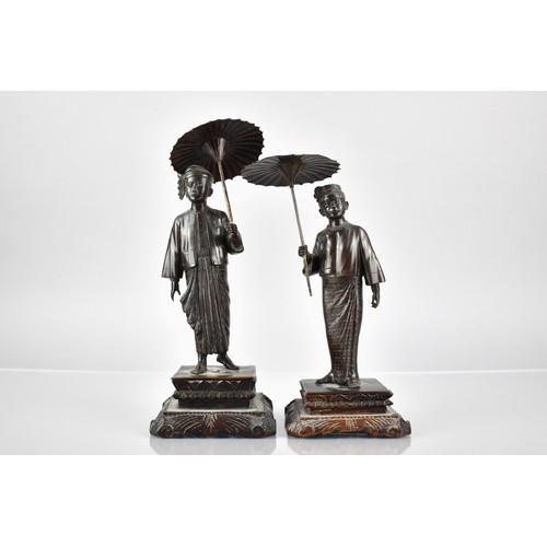 101 - A Pair of Burmese Figures of Gent and Lady with Parasols, One Base Inscribed 'MG MYAI MANDALAY' on C... 