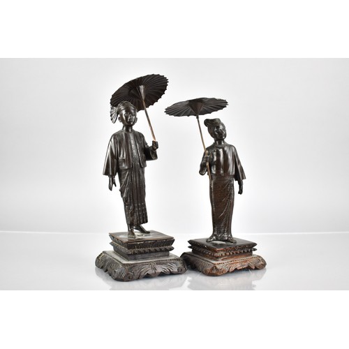 101 - A Pair of Burmese Figures of Gent and Lady with Parasols, One Base Inscribed 'MG MYAI MANDALAY' on C... 