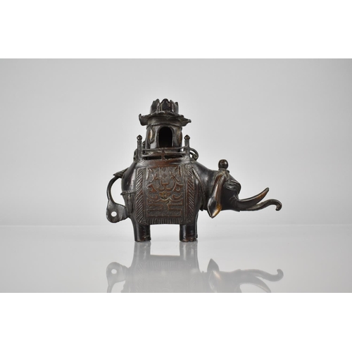 421 - A Cast Chinese Bronze Censer in the Form of an Elephant with Pierced Pagoda Howdah Top, 14cms High