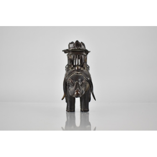 421 - A Cast Chinese Bronze Censer in the Form of an Elephant with Pierced Pagoda Howdah Top, 14cms High