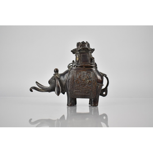 421 - A Cast Chinese Bronze Censer in the Form of an Elephant with Pierced Pagoda Howdah Top, 14cms High