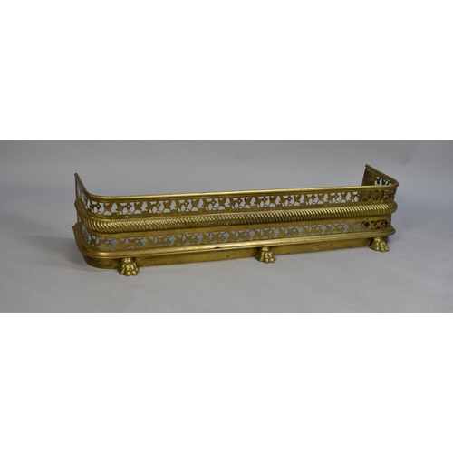 201 - An Early 20th Century Tall Pierced Brass Fire Kerb with Three Claw Feet, 120cms Wide and 25cms High