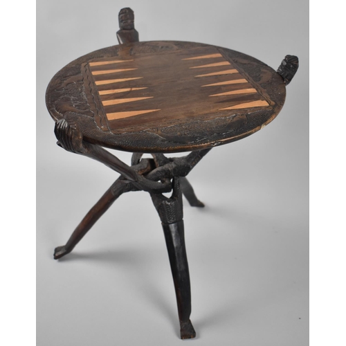 209 - An African Tribal Souvenir, Circular Topped Folding Backgammon Table,Border Carved with Fish, 33cms ... 