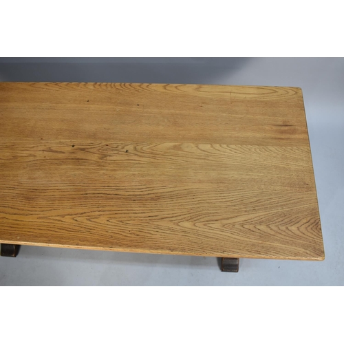 215 - A Mid 20th Century Oak Rectangular Coffee Table with Twin Bulbous Supports, 132cms by 57cms