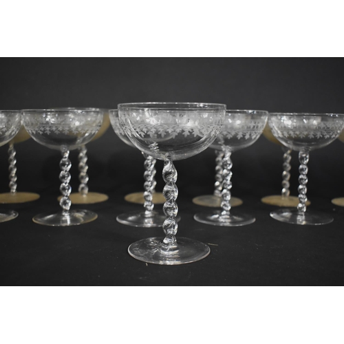 299 - A Set of Thirteen Glass Coupes with Twisted Stem on Circualr Foot, the Bowl Decorated with Etched Pa... 