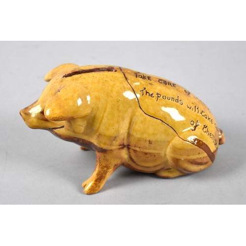 A Ewenny Pottery Glazed Piggy Bank Inscribed 'Take Care of the Pence. The Pounds will Take Care of Themselves', 16cm long