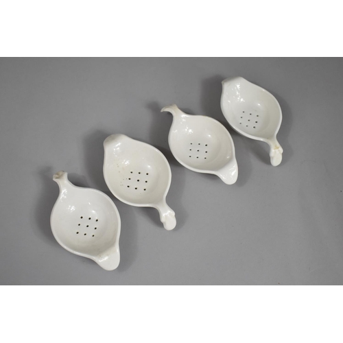 329 - A Set of Four 19th Century Creamware Tea Strainers, with Scrolled Handles and Plain Lips, 13cm wide