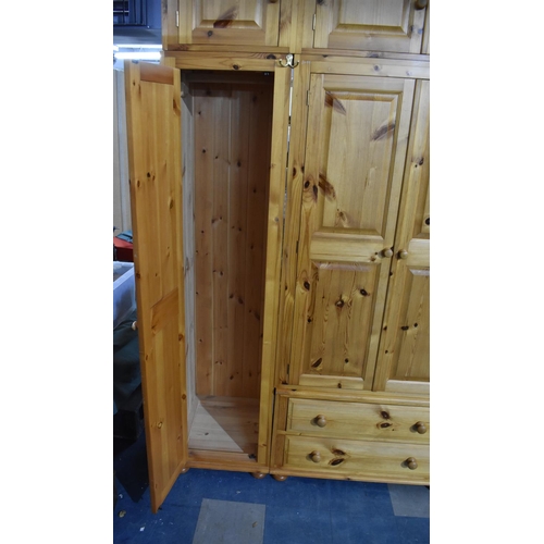 392 - A Large Modern Pine Fitted Bedroom Unit with Hanging Sections, Four Drawers and Raised Cupboards 228... 