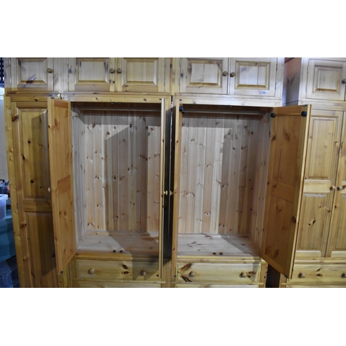 392 - A Large Modern Pine Fitted Bedroom Unit with Hanging Sections, Four Drawers and Raised Cupboards 228... 