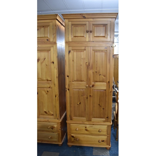 392 - A Large Modern Pine Fitted Bedroom Unit with Hanging Sections, Four Drawers and Raised Cupboards 228... 