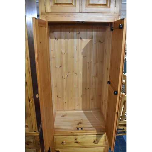 392 - A Large Modern Pine Fitted Bedroom Unit with Hanging Sections, Four Drawers and Raised Cupboards 228... 