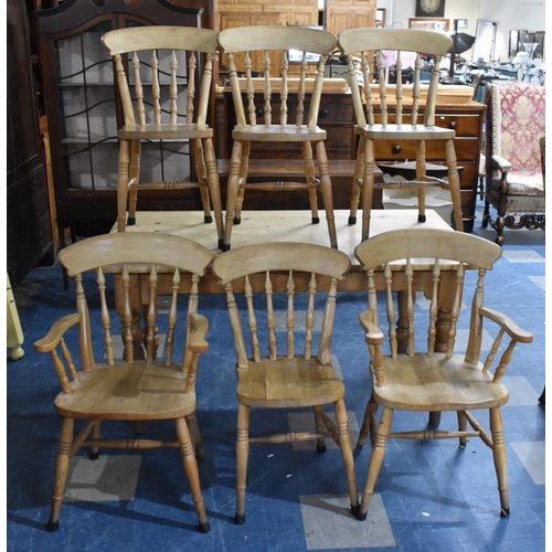 421 - A Pine Rectangular Kitchen Table with Six Chairs to include Two Carvers