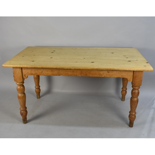 421 - A Pine Rectangular Kitchen Table with Six Chairs to include Two Carvers