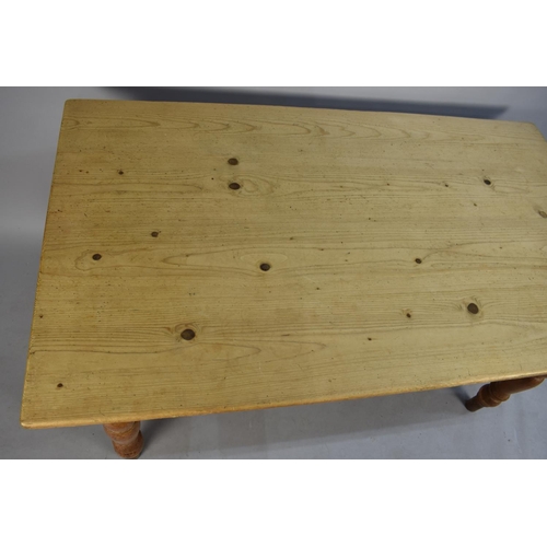 421 - A Pine Rectangular Kitchen Table with Six Chairs to include Two Carvers