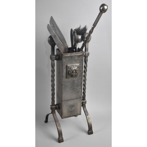 69 - A Matching Oxidized Metal Fire Companion Set with Barley Twist Supports and Range of Tools