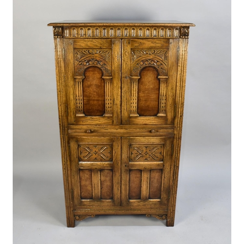 81 - A Mid 20th Century Oak Old Charm Style Cocktail Cabinet with Centre Pull Out Slide, Fitted Top Cupbo... 