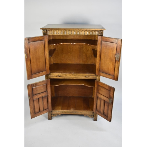 81 - A Mid 20th Century Oak Old Charm Style Cocktail Cabinet with Centre Pull Out Slide, Fitted Top Cupbo... 