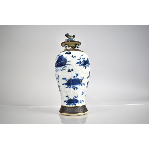 301 - A Chinese Porcelain Blue and White Nanking Crackle Glazed Baluster Vase and Cover, decorated with Bu... 