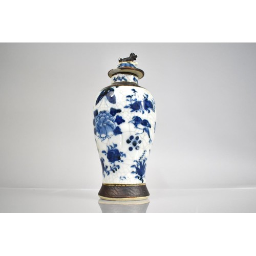 301 - A Chinese Porcelain Blue and White Nanking Crackle Glazed Baluster Vase and Cover, decorated with Bu... 