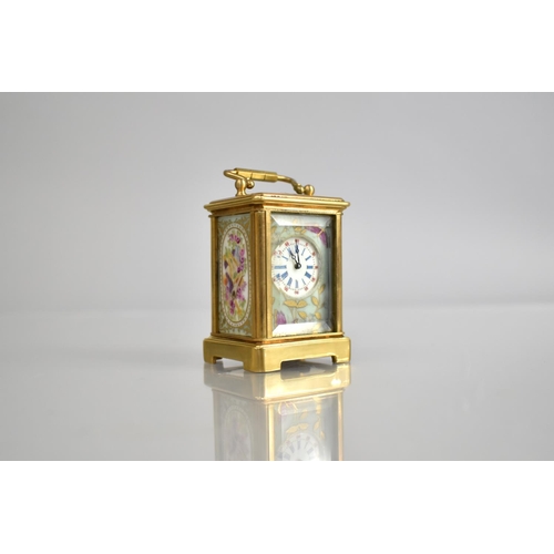 444 - A Reproduction Miniature Gilt and Porcelain Panel Carriage Clock in the Sevres Style with Key and Wo... 