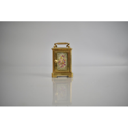 444 - A Reproduction Miniature Gilt and Porcelain Panel Carriage Clock in the Sevres Style with Key and Wo... 