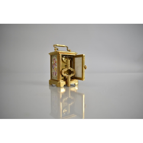 444 - A Reproduction Miniature Gilt and Porcelain Panel Carriage Clock in the Sevres Style with Key and Wo... 