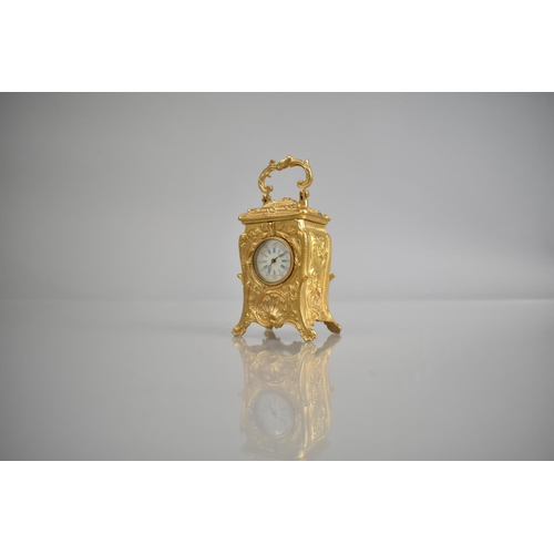 443 - A Miniature Gilt Bronze Reproduction Carriage Clock in the French Art Nouveau, with Key and Working ... 