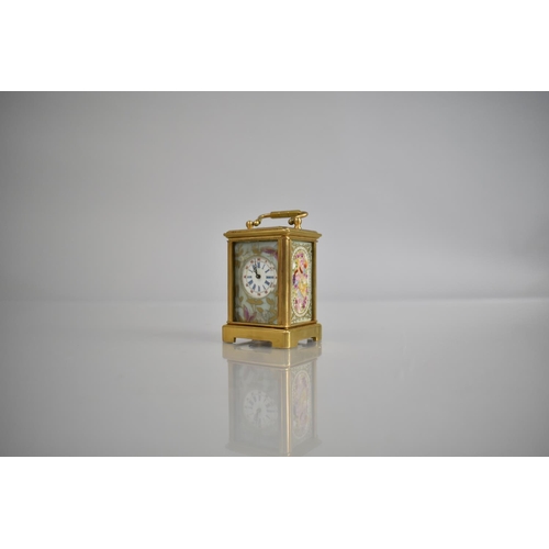 444 - A Reproduction Miniature Gilt and Porcelain Panel Carriage Clock in the Sevres Style with Key and Wo... 