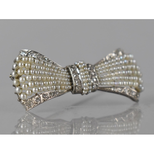 An Exquisite Early 20th Century White Metal, Diamond and Pearl Brooch by Gattle, Two Centre Rows of Fine Seed Pearls Threaded to Bars and with Matched Rows of Five Old Round Cut Diamonds Either Side, Grain Set in White Metal To Six Radiating Rows of Graduated Pearls and Edged by Two Rows of Graduated Round Cut Diamonds, 47mm Wide, Largest Diamond 2.2mm Diameter, Largest Pearl 2mm Diameter, 8.6gms, Unmarked but Signed Gattle to Pin
