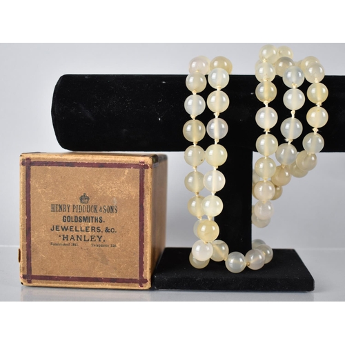 210 - A Long String of Large Opaque Quartz Beads, 140cms Long on a Knotted Cotton Thread, Each Bead Approx... 