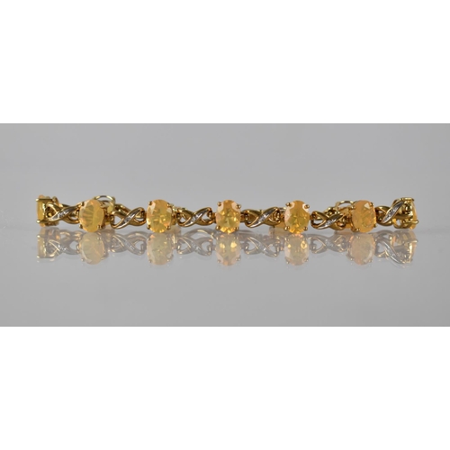 72 - A 9ct Gold, Fire Opal and White Sapphire Bracelet, Eleven Oval Cut, Opals Measuring Approx 8mm by 5.... 