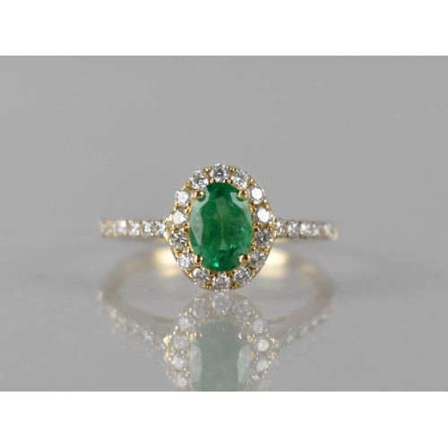 83 - A 14ct Yellow Gold, Emerald and Diamond Dress Ring, Central Oval Emerald Measuring 7x5mm Approx, (0.... 