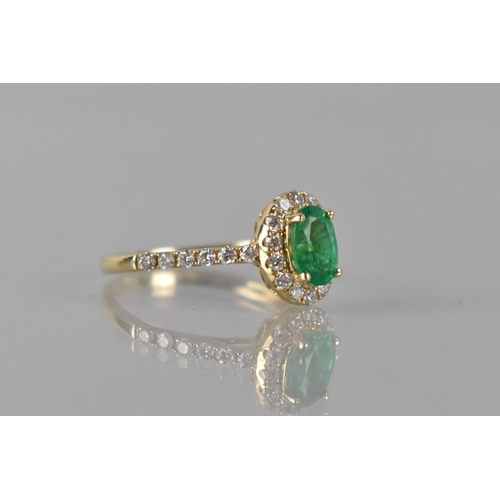 83 - A 14ct Yellow Gold, Emerald and Diamond Dress Ring, Central Oval Emerald Measuring 7x5mm Approx, (0.... 