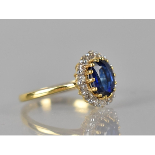 85 - An 18ct Gold, Kyanite and Diamond Cluster Ring, Central Raised Claw Set Oval Cut Stone Measuring 1.6... 