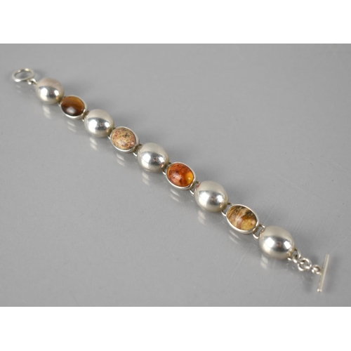 176 - A Mexican Silver Eight Panel Bracelet Comprising Large Cabochon Jasper, Amber and Tigers Eye Stones ... 