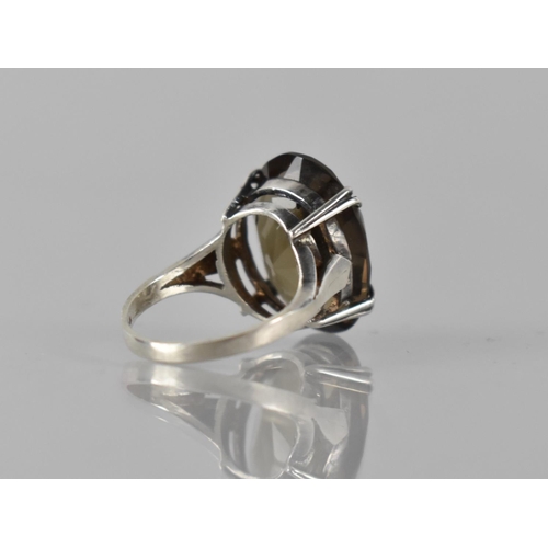 180 - A Silver and Smokey Quartz Cocktail Ring, Central Oval Cut Stone Measuring 20mm by 13mm and Raised o... 