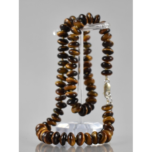 186 - A Tigers Eye and Silver Mounted Necklace, 78 Disc Shaped Beads on a Knotted Cord, with a Silver Lobs... 