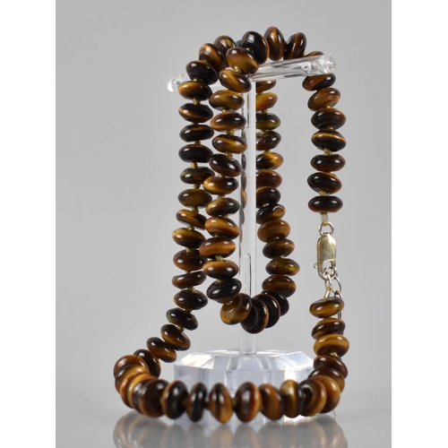 186 - A Tigers Eye and Silver Mounted Necklace, 78 Disc Shaped Beads on a Knotted Cord, with a Silver Lobs... 