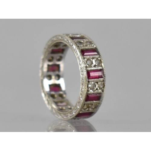 25 - An Elizabeth II 9ct White Gold, Ruby and White Sapphire Eternity Ring, Eleven Baguette Cut Rubies Me... 