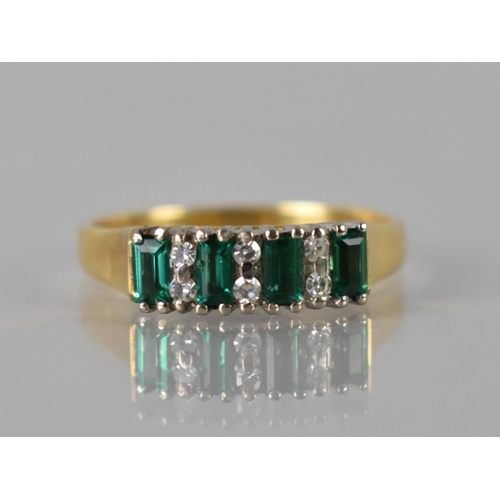29 - An Emerald and Diamond Ladies Dress Ring in 18ct Gold, Four Baguette Cut Emeralds Measuring approx 3... 