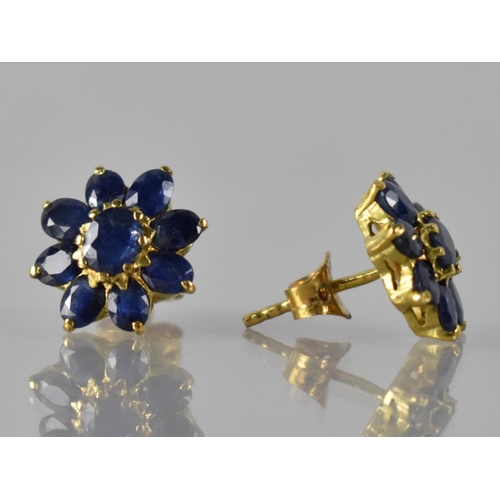 35 - A Pair of Sapphire and Gold Coloured Metal Cluster Earrings, Central Claw Set Oval Cut Sapphire Meas... 
