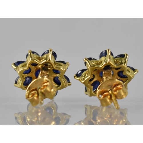 35 - A Pair of Sapphire and Gold Coloured Metal Cluster Earrings, Central Claw Set Oval Cut Sapphire Meas... 