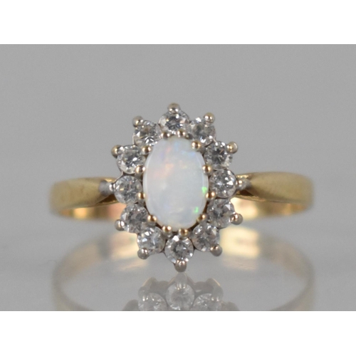 40 - A 9ct Gold, Opal and CZ Ladies Dress Ring, Prong Set Central Oval Cabochon Plaque 6mm by 4mm with a ... 