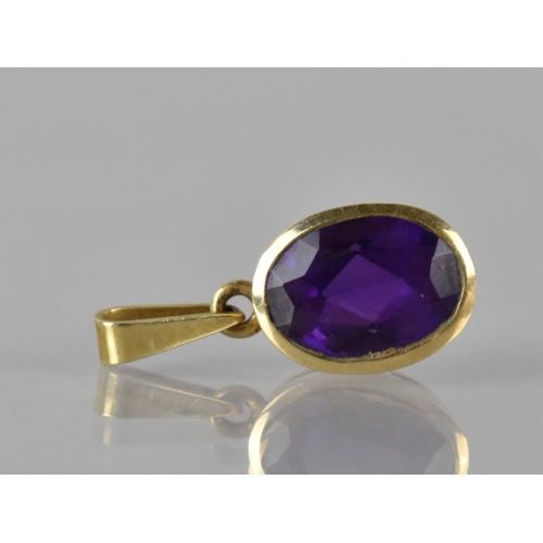 59 - A 14ct Gold Mounted Oval Cut Amethyst Pendant, 11mm by 8mm, Colet Set and Stamped 585 to Bale, Total... 
