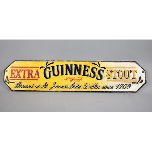 104 - A Reproduction Cast Iron Hand Coloured Sign for Guinness Extra Stout, 56cm Wide