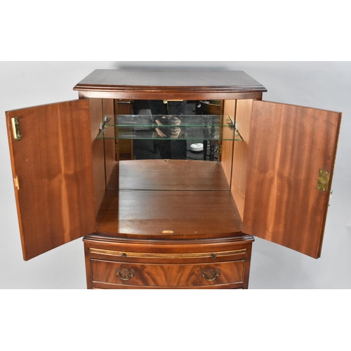 106 - A Modern Mahogany Bow Fronted Cocktail Cabinet, the Panelled Doors Opening to Shelved Mirrored Top S... 