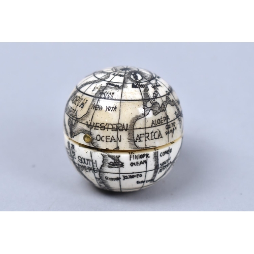 12 - A Reproduction Scrimshaw Style Combination Globe, Compass and Sundial, 3.75cms Diameter