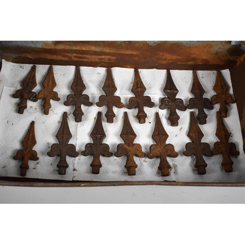 174 - A Galvanised Tool Tray Containing 15 Cast Iron Fleur de Lys Fence or Wall Finials, Each 15cm High